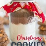Christmas Cookies in a Jar are a great teacher gift or hostess gift to bring to a holiday gathering. Add a delicious cookie recipe to a mason jar and top it with holiday fabric for a simple homemade gift.