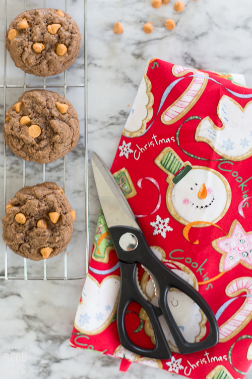 Christmas fabric and scissors next to a rack of cookies