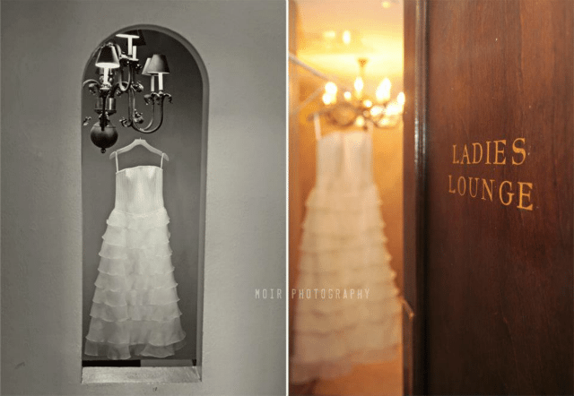 wedding dress hanging in doorway 