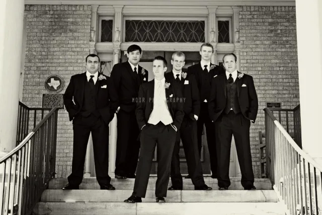 groomsmen standing on chapel steps