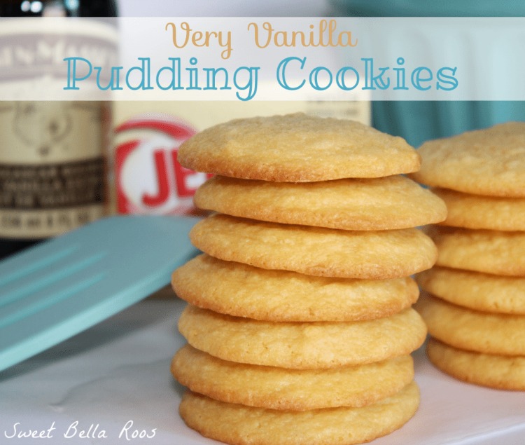 two stacks of vanilla pudding cookies. a bottle of vanilla extract and a box of instant pudding sits in the background. 