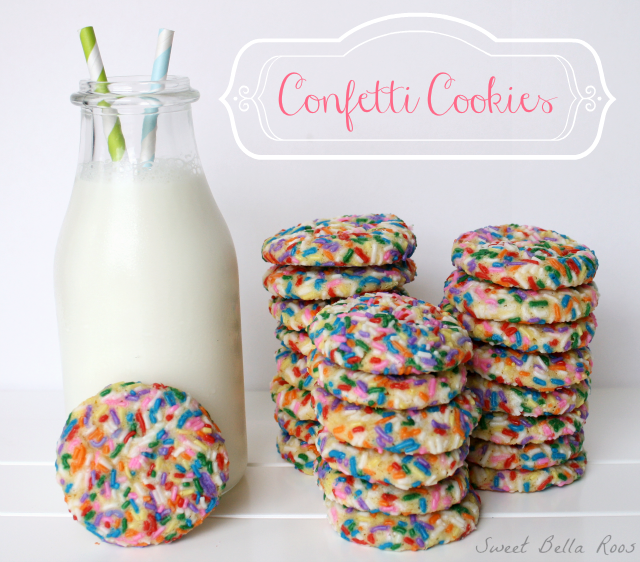 Three tall stacks of confetti cookies next to a pitcher of milk. 