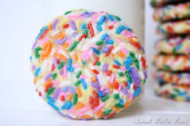A rainbow sprinkle cookie on its side. 