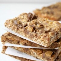 Peanut Butter Cup Granola Bars stacked between parchment paper