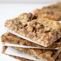 Peanut Butter Cup Granola Bars stacked between parchment paper
