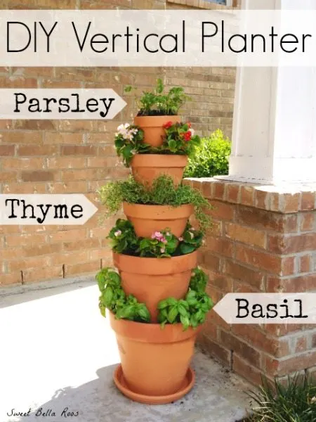 stacked flower pots with flowers and herbs
