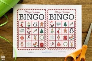 Christmas bingo printable on a table with scissors and ribbon