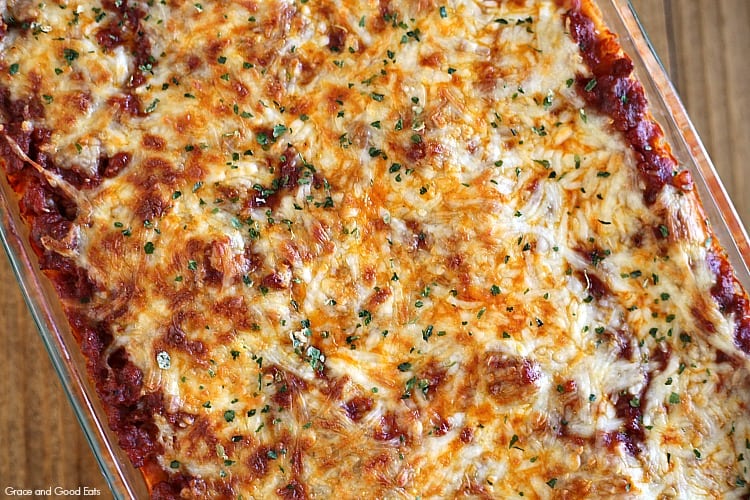 casserole dish of lasagna topped with cheese and parsley