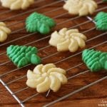 green and white Spritz cookies on a baking rack