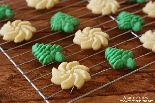 green and white Spritz cookies on a baking rack