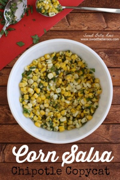 copycat chipotle corn salsa in a white bowl. cilantro and lime is in the background.