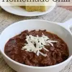 chili topped with white cheese with a plate of cornbread