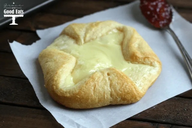 a crescent roll cream cheese danish on a piece of parchment paper 