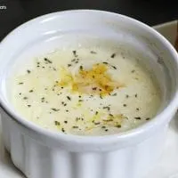 egg baked in a small white ramekin sprinkled with pepper