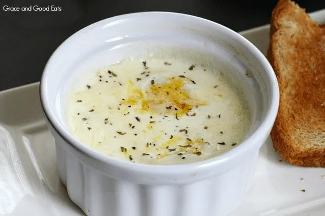 egg baked in a small white ramekin sprinkled with pepper