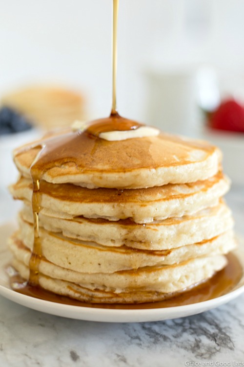 syrup pouring down over a stack of homemade pancakes