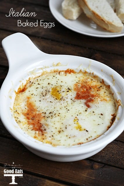 two eggs with marinara sauce and topped with cheese in a round white dish