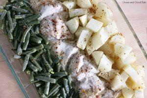 casserole dish with green beans, chicken, and potatoes