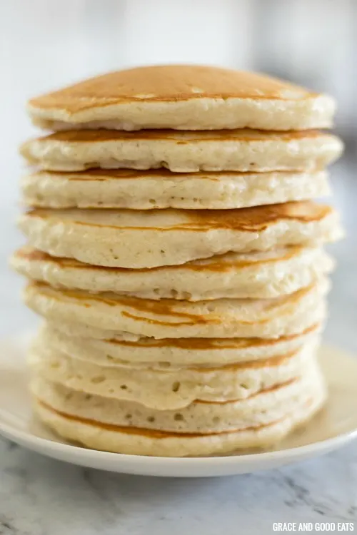 Tall stack of fluffy pancakes on a plate