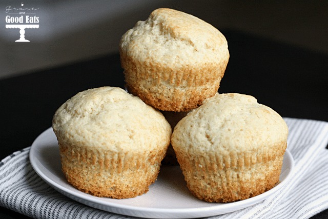 Three plain muffins on a white plate. 
