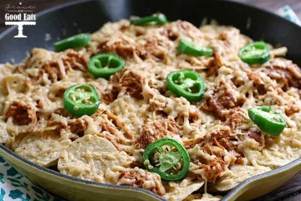 tortilla chips covered in cheese and shredded chicken
