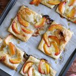 puff pastry topped with brie, peaches, and honey