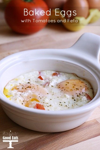 a white dish with oven baked eggs with tomatoes and feta cheese