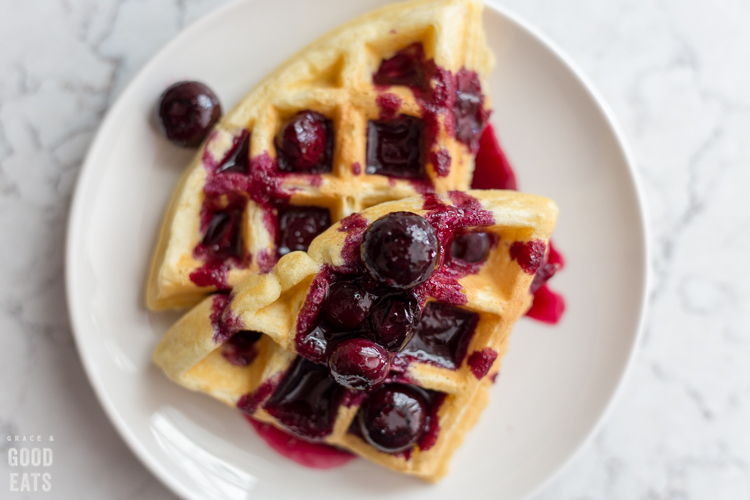 plate of waffles with blueberry syrup