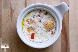 baked eggs with feta and red peppers in a ramekin