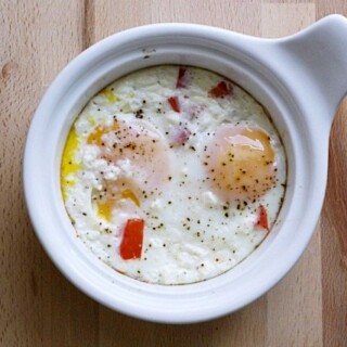 baked eggs with feta and red peppers in a ramekin