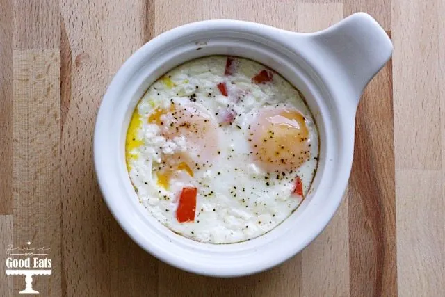 baked eggs with feta and red peppers in a ramekin