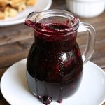 blueberry syrup in a small glass pitcher