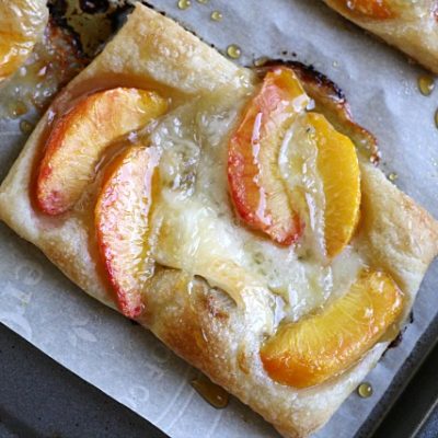 close-up puff pastry tart with peaches