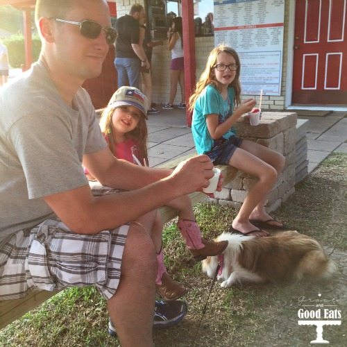 family enjoying snowcones outside