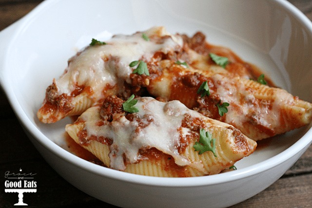 three stuffed pasta shells with ground beef in a white bowl