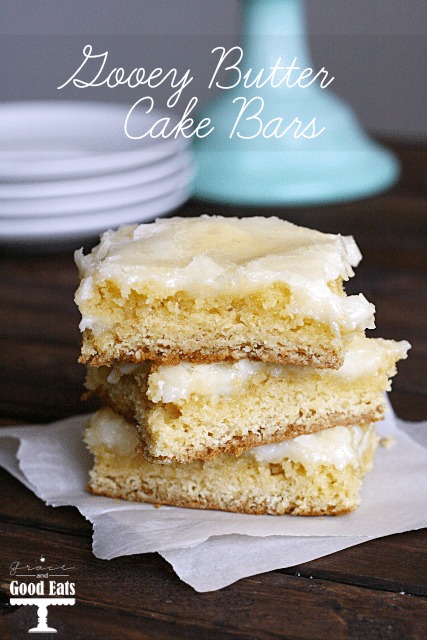 stack of three gooey butter bars on parchment paper 