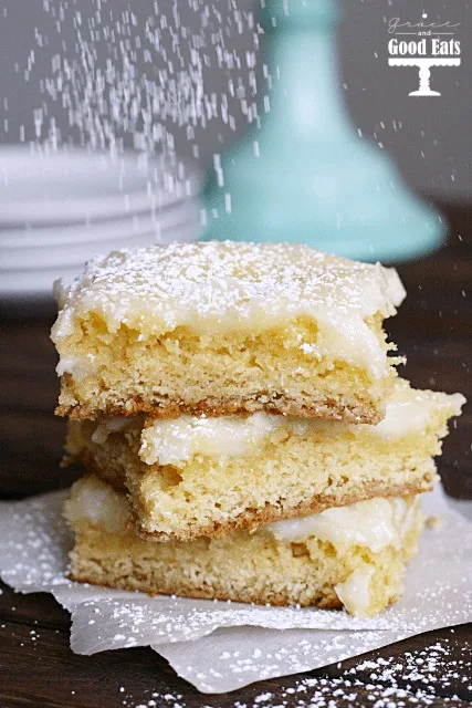 gooey butter bars being dusted with powdered sugar 