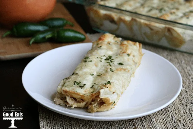 two cream cheese chicken enchiladas on a white plate