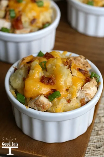 white dish with potatoes topped with melted cheese