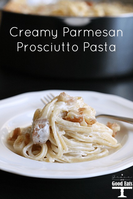 Parmesan prosciutto pasta on a white plate with a fork. 