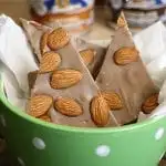 chocolate candy with almonds in a green bowl