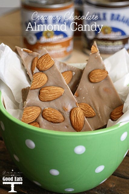 chocolate candy with almonds in a green bowl