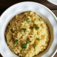 creamy Parmesan risotto topped with parsley in a bowl