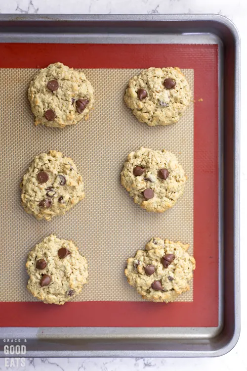 baked protein chocolate chip cookies on a baking sheet