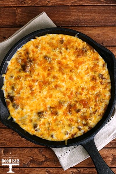 Overhead view of enchilada dip in a cast iron skillet. 