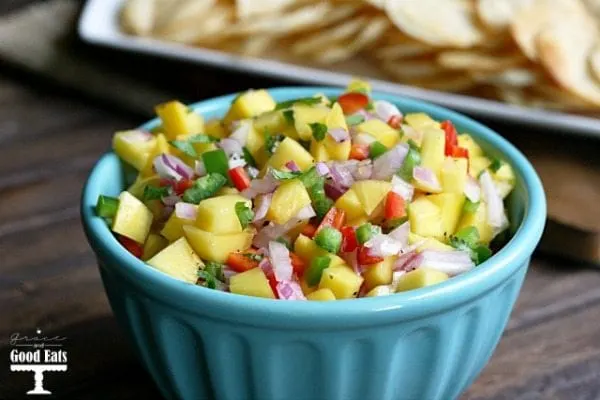 blue bowl full of fresh mango salsa