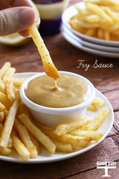 french fry being dunked into bowl of fry sauce