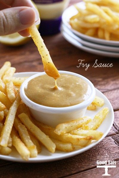 french fry being dunked into bowl of fry sauce