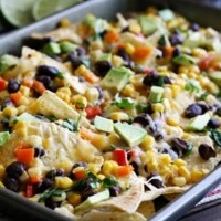 These Spicy Black Bean Four Cheese Nachos are perfect for a crowd or a weeknight dinner!