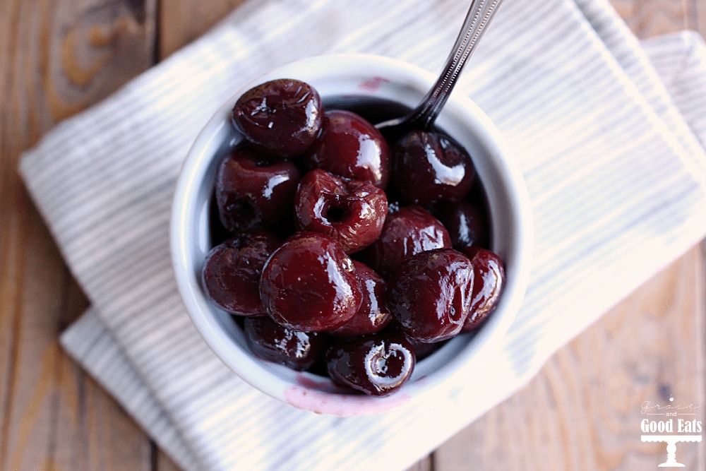 overhead view of roasted bourbon cherries in a white dish